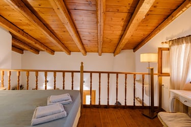 Tonia's Cottage maisonette bedroom with a wooden roof