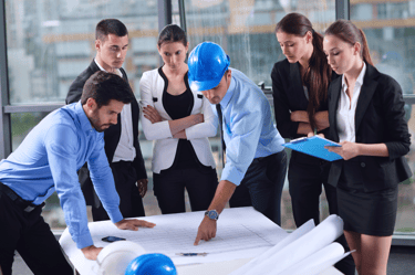 Project Manager analyzing a strategic plan at a work desk.