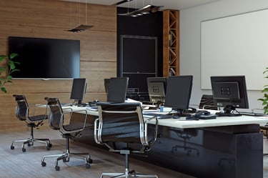 a conference room with a desk and a television