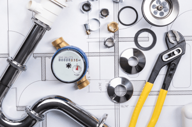 a variety of plumbing tools on a table