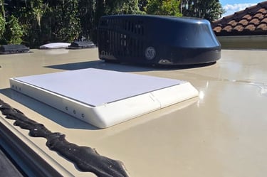 RV roof showing a vent and a Starlink mini dish..