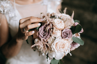 a woman in a wedding dress holding a bouquet