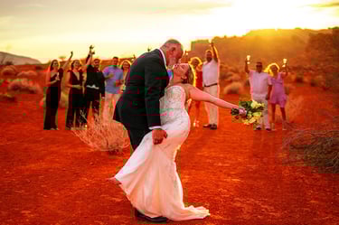 Newlyweds kissing during a sunset desert wedding ceremony at Valley of Fire State Park.
