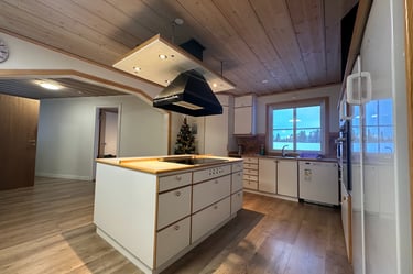 a kitchen with a stove top and Christmas tree