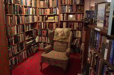 Chair in reading nook filled with used books at Chester Creek Books in Duluth, Minnesota