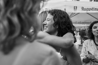 Bride hugging a wedding guests at reception.