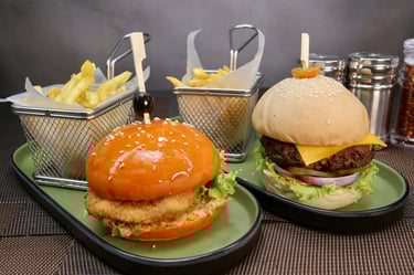 two plates of beef and chicken burger