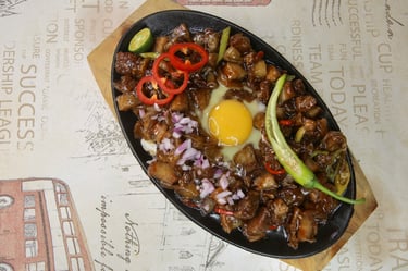 a plate of sizzling sisig