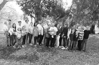 Family picture, black and white, in woods.