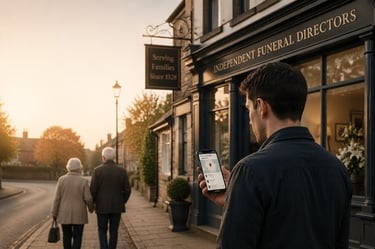 Young man searching for a funeral director on his phone outside an independent funeral home.