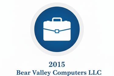 Bear Valley Computers LLC 2015 logo featuring a white briefcase icon inside a blue circular badge.