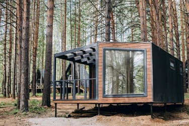 a tiny cabin in the woods with a bicycle