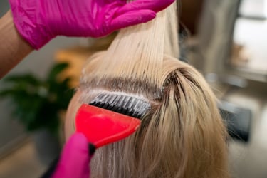 a woman is brushing her hair with a brush