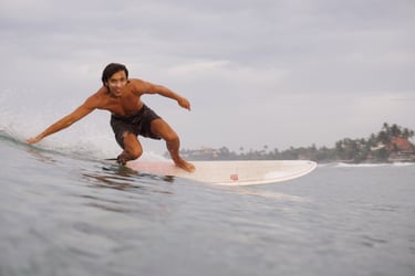 man riding surfboard looking into camera
