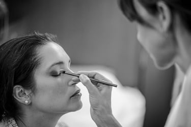 The bride getting her makeup done before the wedding