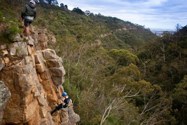 Participant abseiling down a sheer cliff during a Full day Rock Solid Adventure in South Australia