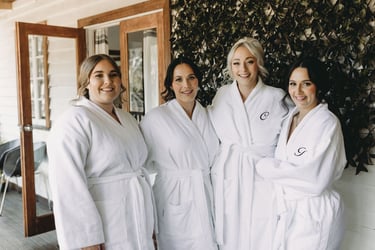 a group of women in robes standing in front of a house