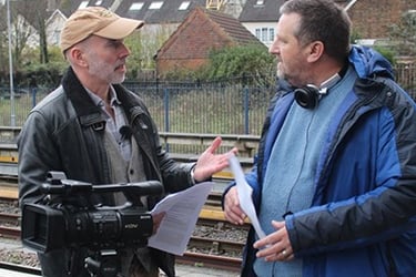 Chris Kirk and Stephen Cranford discussing a shot