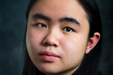 a woman with long hair and a gray shirt