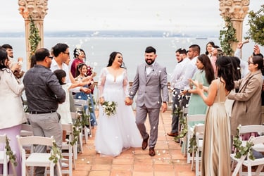 a bride and groom walking down the aisle of a wedding ceremony