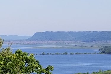 a wide river with a bluff in the background