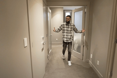 a man in a plaid shirt is standing in a hallway