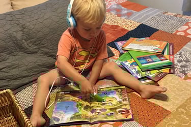 boy reading on bed with headphones