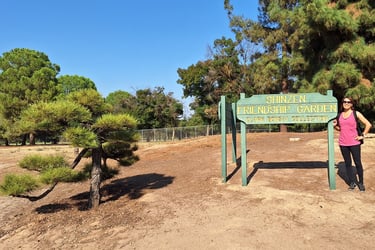Janet with the Shinzen Friendship Garden Sign