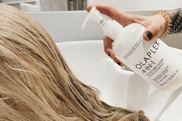 Hair model applying Olaplex during color treatment.