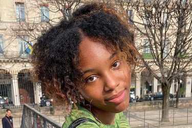 a woman with curly hair and a green shirt qui est adhérente de néoléa