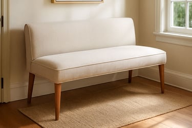 Neutral upholstered bench settee in a Los Angeles entryway with soft light, warm wood flooring, and layered woven textures.