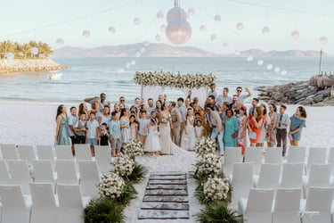 a group of people standing in front of a beach