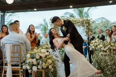 a bride and groom kissing in a wedding ceremony