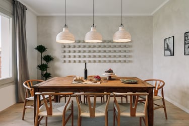 Dining area with elegant decor, wooden table and chairs, custom lighting and calming design by SAVIA