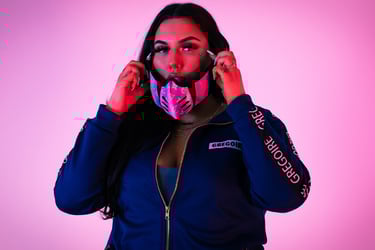 a woman in a blue jacket and a pink mask