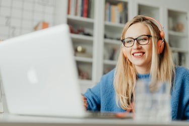 a woman wearing headphones and headphones, sitting at a desk