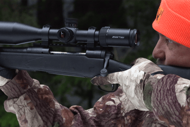 Image Link showing a hunter aiming Savage 30.06 with Zerotech Scope