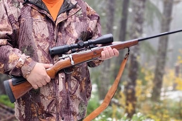 Image link of a hunter holding a Mauser rifle linking to a blog post about Mauser rifles