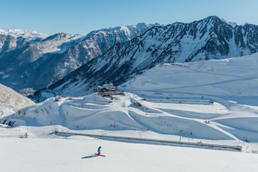 a person skiing down a mountain with a lot of snow