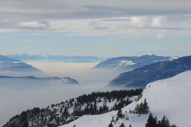 a person on a ski slope with a view of the mountains