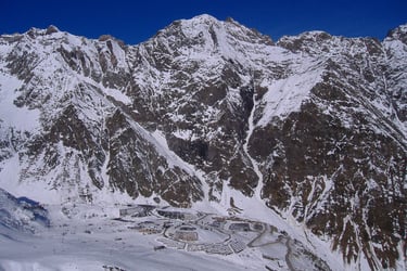 a person on a snowboard in the mountains