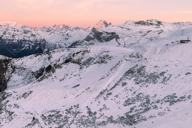a person on a snowboard in the mountains