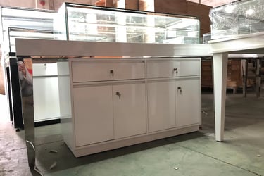 Modern white jewelry display counter with glass showcase and locking storage cabinets for retail stores.