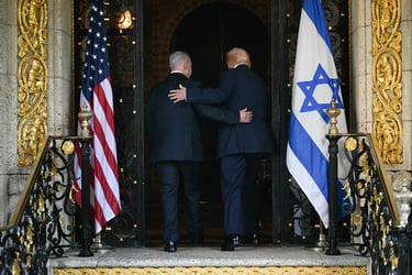 Netanyahu and Trump entering together between the American Flag and the Flag Of Israel