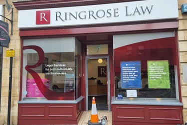 Front of Ringrose Law firm, with large branded windows and freshly red-painted detailing.