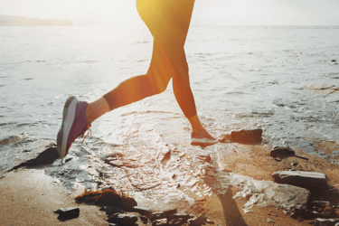 a person is running on the beach for optimizing health