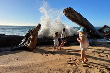 Kids playing in the ocean in Kauai Hawaii