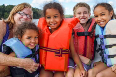 Family riding on boat in life jackets