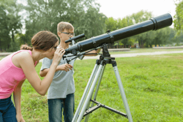 Kids using telescope