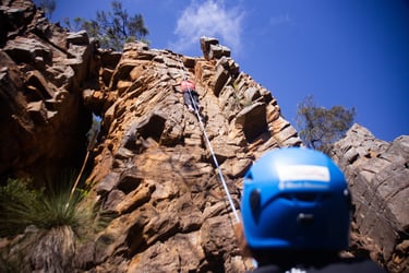 Group enjoying rock climbing on natural cliffs with expert instructors during a Full Day adventure